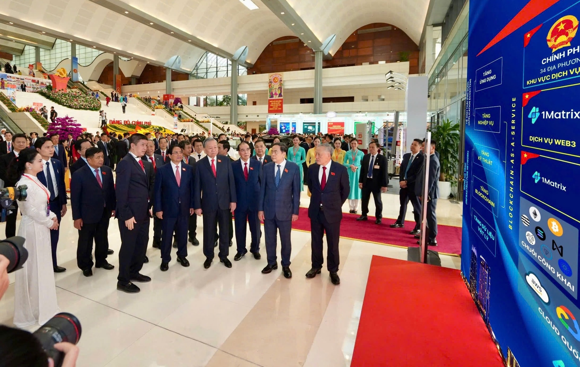 1. Tổng Bí thư Tô Lâm thăm khu vực trưng bày và nghe ông Phan Đức Trung chia sẻ về Mạng Dịch vụ Đa chuỗi Blockchain Việt Nam (VBSN)