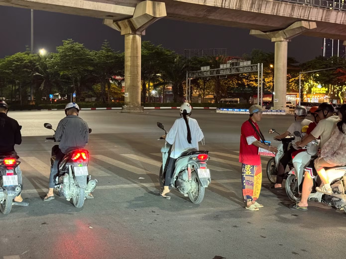 Tình trạng bán hàng rong dưới lòng đường xuất hiện tại nhiều nút giao đông phương tiện ở Hà Nội. (Ảnh: Đức Hiếu) Người bán hàng tràn xuống ngã tư ở Hà Nội, nguy cơ tai nạn rình rập - Ảnh 1.