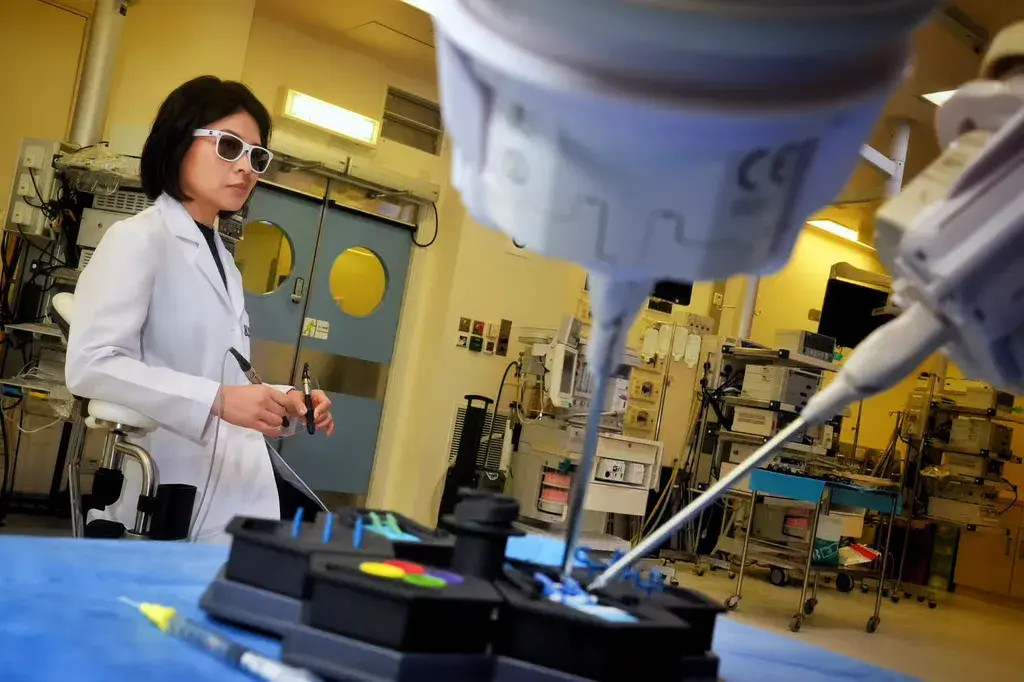 Dr Velda Chow operates the robotic microsurgical platform. Photo: Elson Li