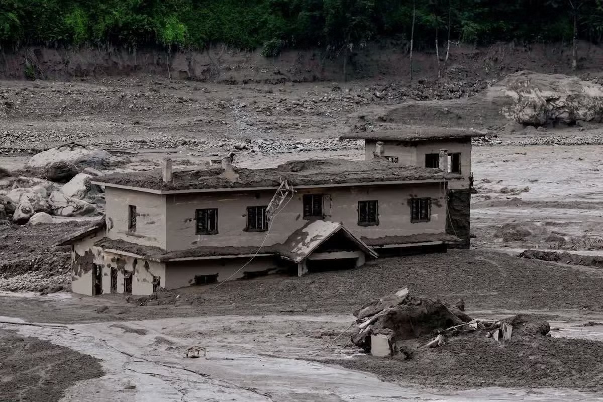 Bùn đất nhấn chìm một ngôi nhà ở Nuwakot (Nepal). (Ảnh: Reuters) Lũ quét ở biên giới Nepal - Trung Quốc: Hy vọng tìm thấy người sống sót mờ dần - Ảnh 1.